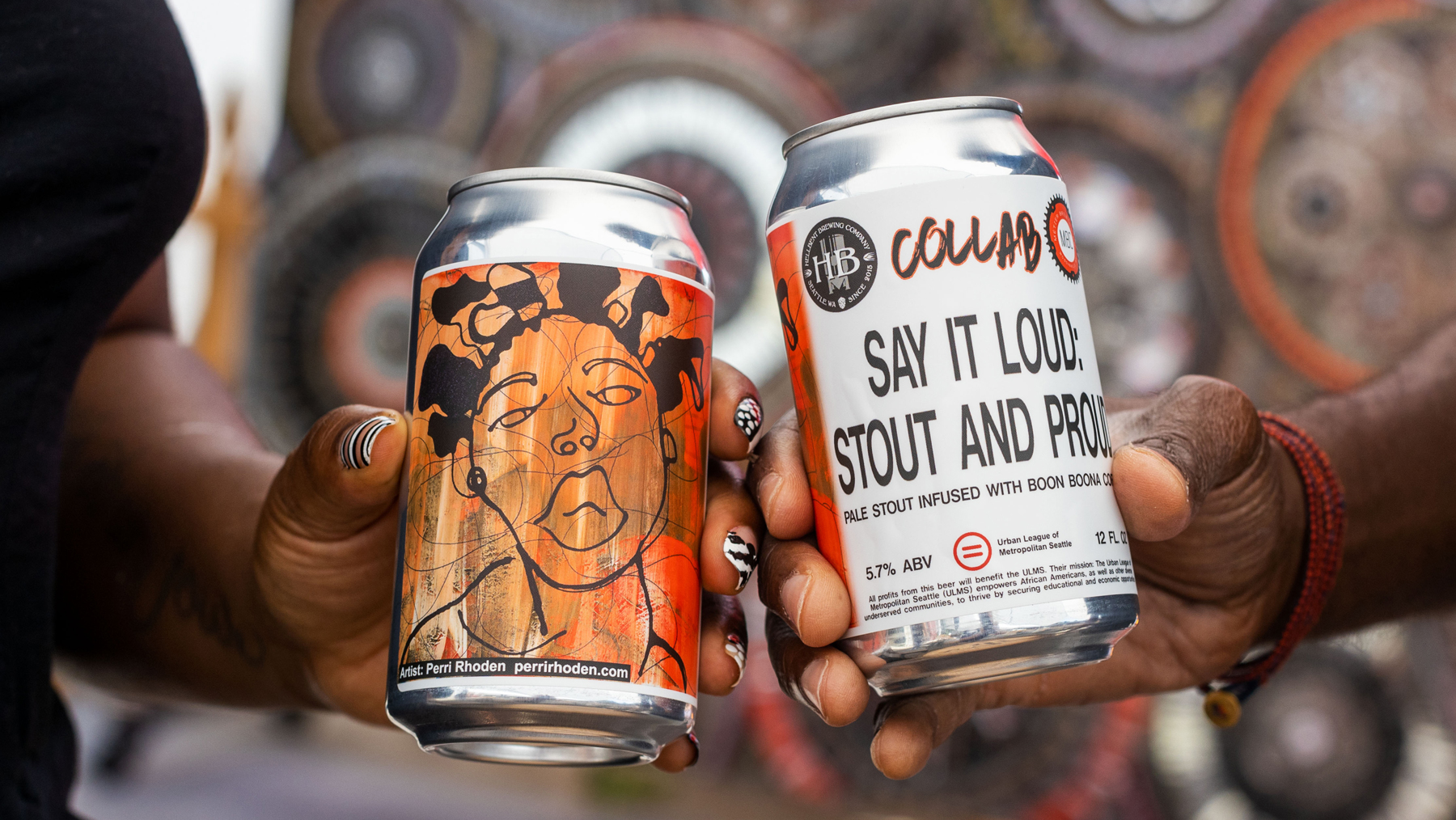 A closeup of two hands, each holding a can of Say It Loud, Stout and Proud.